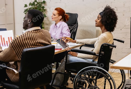 Preview: Multiracial coworkers using tablet and analyzing charts in coworking space