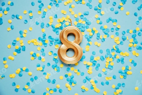 Preview: Number 8 eight golden celebration birthday candle on yellow and blue confetti Background