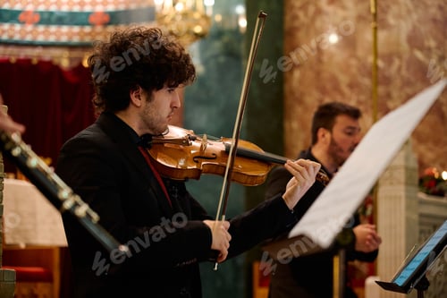 Preview: Musicians performing classical music during a concert in a church setting