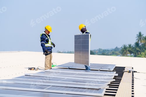 Preview: workers installing solar panels, for efficient energy on rooftop