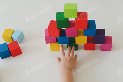Preview: Child hands playing with montessori toys, educational toys, arranging and sorting colors and sizes.