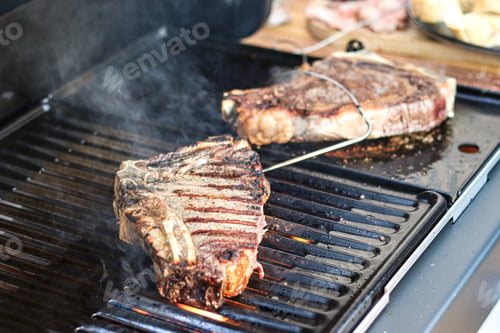 Preview: Steak with cooking on grill. Grilling steak.