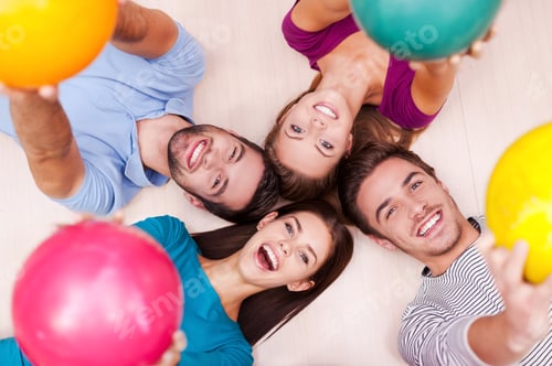 Preview: We are happy together. Cheerful friends lying down and outstretching their bowling balls