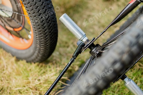 Preview: Close-Up of Bicycle Pedals and Wheels on Grass