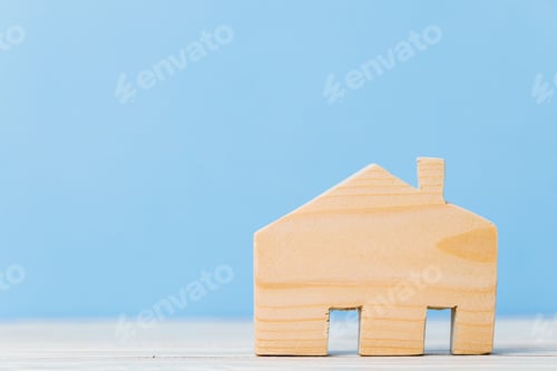 Preview: Wooden house miniature on wooden surface close up