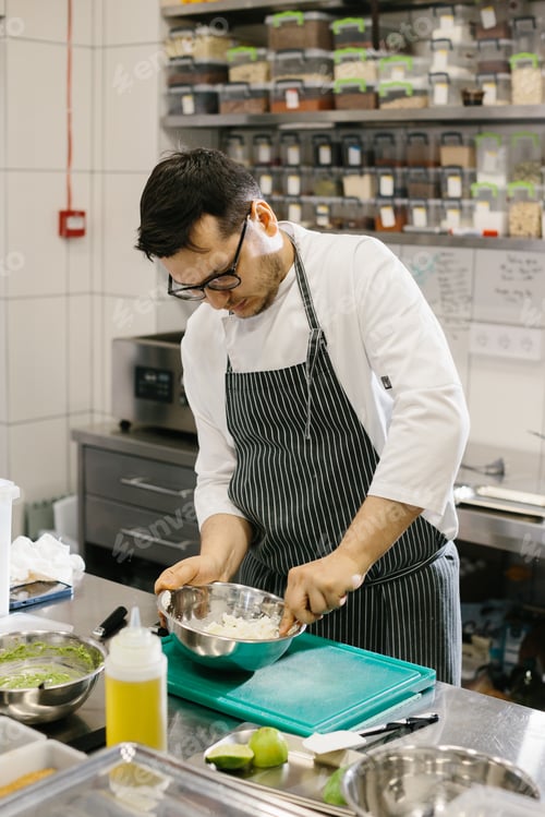 Preview: The chef prepares food in the modern spacious kitchen.