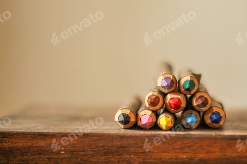Preview: a close up of a bunch of colored pencils on a wooden table