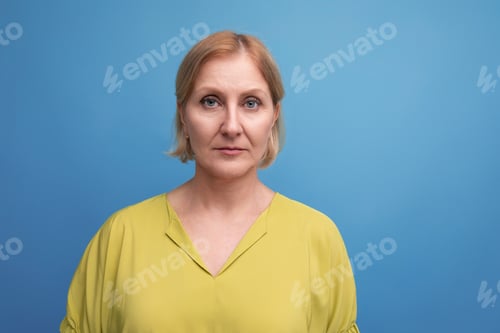 Preview: portrait of serious healthy middle aged blond woman with grimace