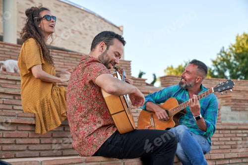 Preview: Men playing guitars near dog and woman