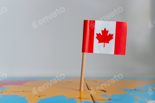 Preview: Small flag of Canada on a wooden stick fixed on the globe