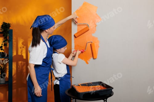 Preview: Young people painting walls with orange
