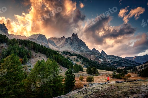 Preview: Sunset over Claree Valley with Main De Crepin peak and river flow through in larch forest