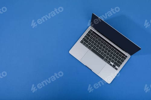 Preview: Open laptop on blue background, space for text