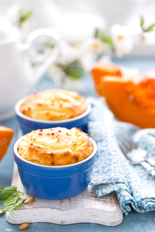 Preview: Delicious mini casserole with cottage cheese and pumpkin for breakfast. White background. Closeup