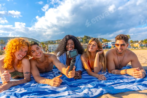 Preview: Group of young friends taking a selfie on the beach with action camera