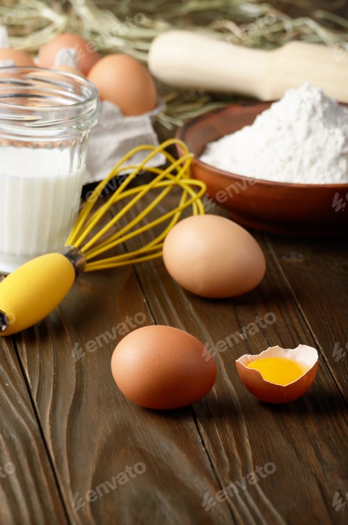 Preview: Raw organic brown chicken broken eggs with yolk flour milk and w
