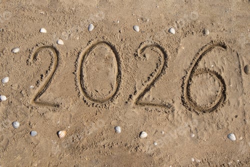 Preview: The numbers 2026 are handwritten on the sand, on the seashore, seashell.
