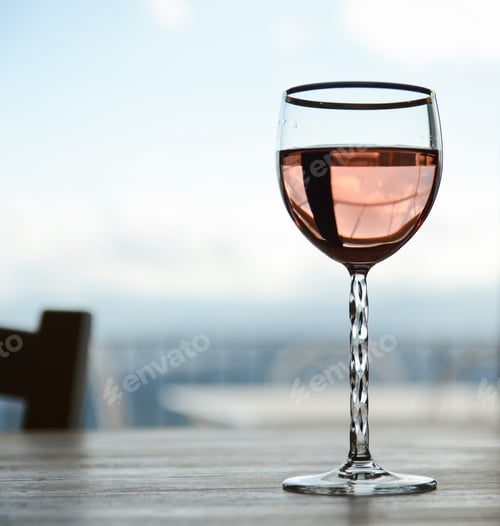 Preview: A good glass of rose wine on a wooden table