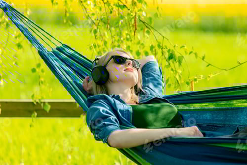 Preview: Woman Relaxes in Hammock with Music in Nature