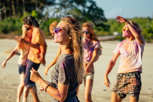 Preview: multinational multicultural mixed race friends in holi dust on beach in Goa