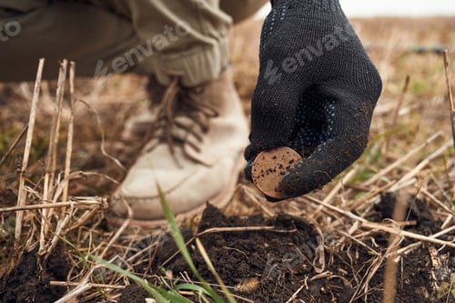 Preview: Close up view of man that found old coin on the field