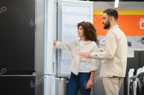 Preview: Couple choosing refrigerator in electronics store examining home appliance features