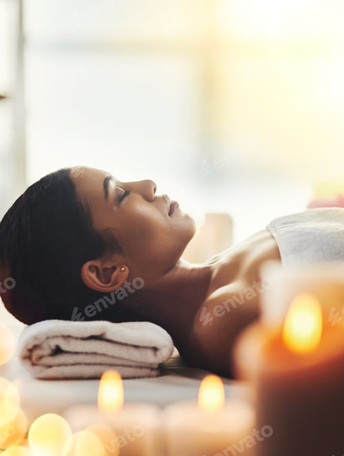Preview: Shot of an attractive young woman relaxing on a massage table at a spa