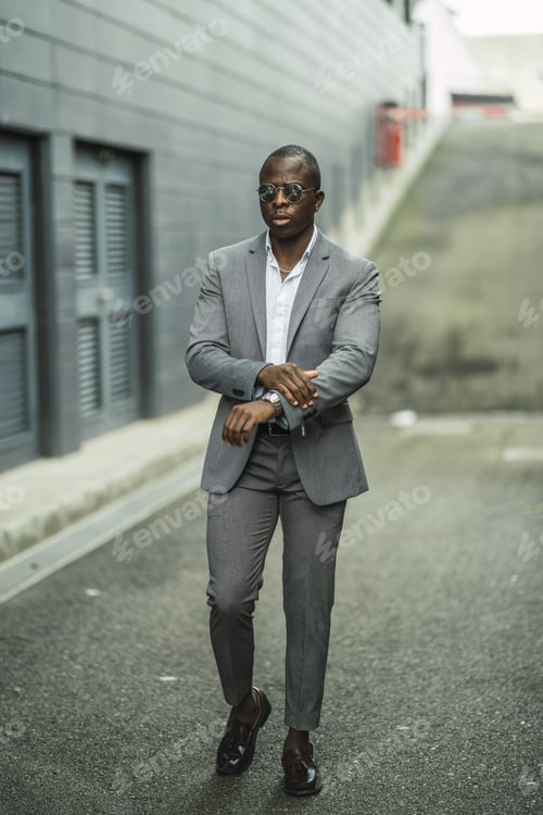 Preview: Shallow focus shot of a handsome confident African male in a suit and sunglasses