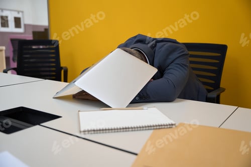 Preview: Adult male lying at desk in the office