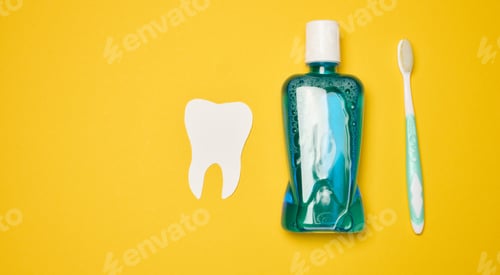 Preview: Mouthwash and toothbrush on yellow background, top view