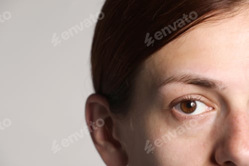 Preview: Woman with beautiful eyes on light grey background, closeup. Space for text