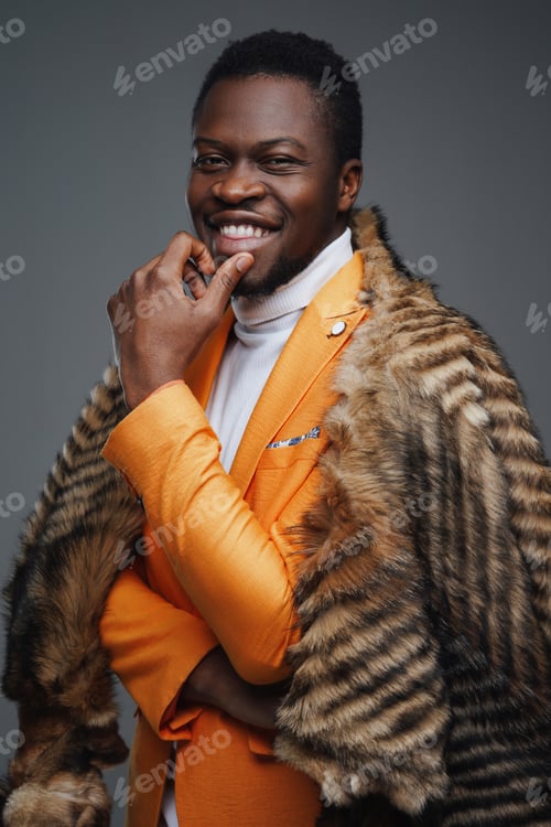 Preview: Happy african man with fur against gray background