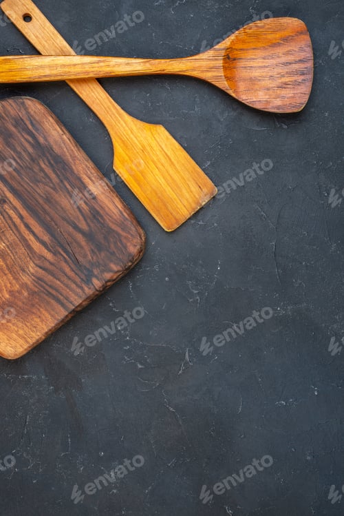 Preview: top view wooden board wooden spoons on dark background copy place