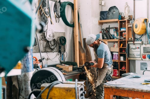 Preview: Axe maker using steel grinder in workshop