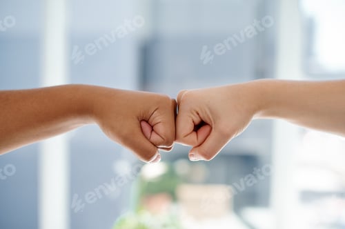 Preview: Cropped shot of two unrecognizable businesswomen fist bumping each other inside an office