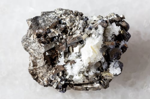 Preview: sample of raw arsenopyrite mineral on white marble