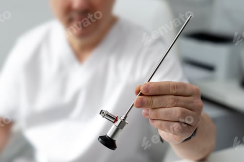 Preview: Close up view, doctor holding medical endoscope, selective focus. Health care concept.