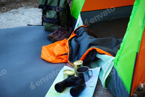 Preview: Sleeping bag and other camping gear outdoors