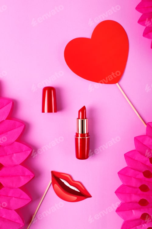 Preview: Red lipstick on pink background with party paper fans.