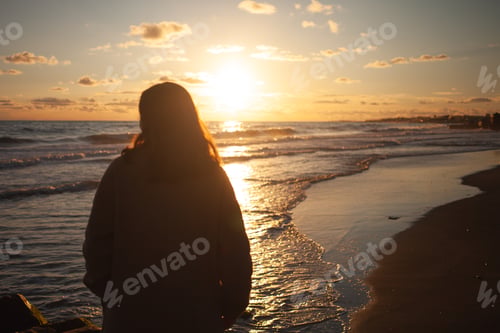 Preview: Sunset beach walk for serene woman.