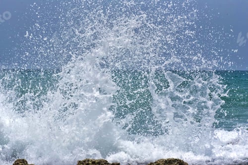 Preview: Large crashing splashing waves on a rocky shoreline