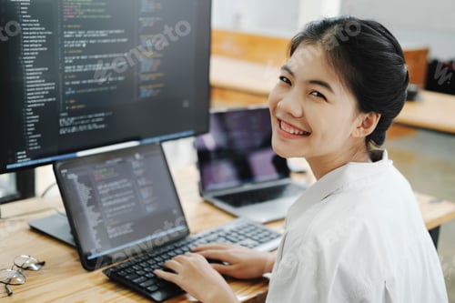 Preview: Young programmer working on desktop PC in office of software company.