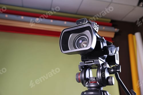 Preview: Modern video camera in stylish studio, low angle view. Space for text