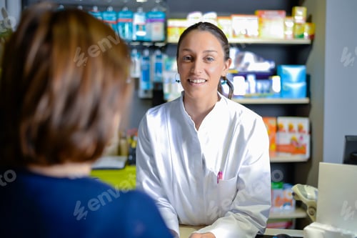 Preview: pharmacist staff counseling customer about drugs usage in modern pharmacy