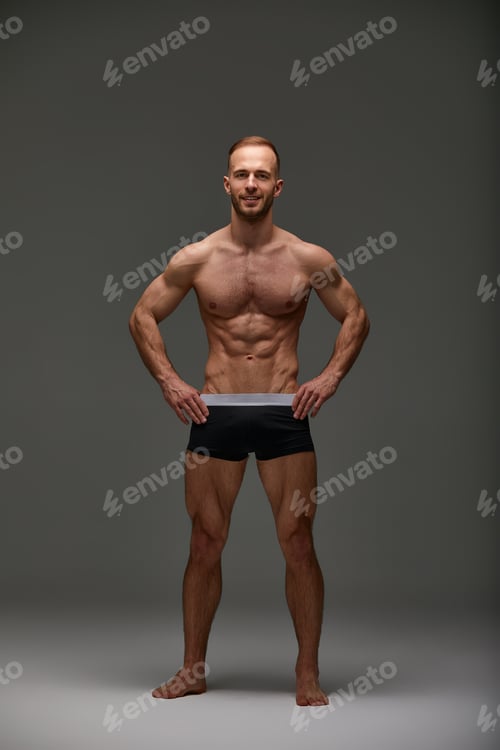 Preview: Young male athlete posing. Handsome athletic male power guy. Fitness muscular person. Young athlete