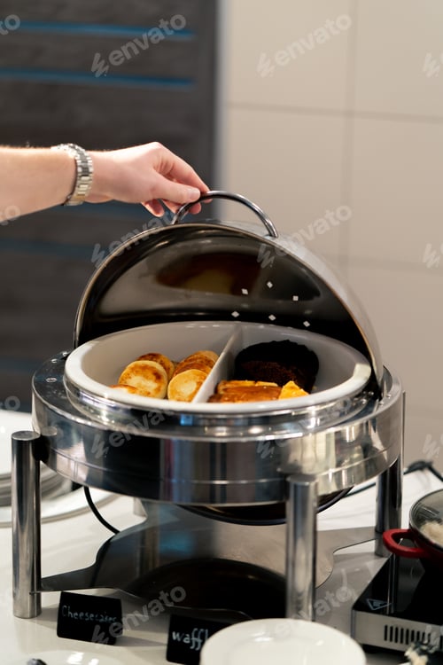 Preview: close-up buffet line breakfast or dinner in hotel beautiful serving of food with plates hospitality