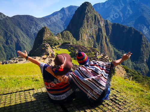 Preview: Couple admiring Machu Picchu mountain, Sacred Valley, and the surrounding peaks from above