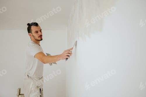 Preview: Man Smoothing Plaster on Wall in Bright Room
