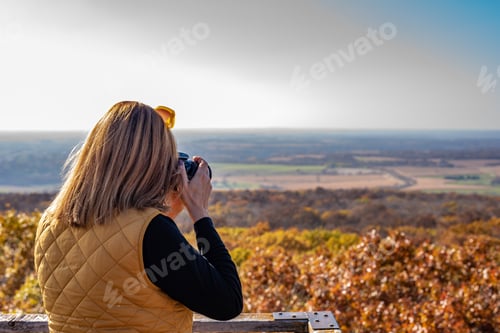 Preview: Woman taking photo of beautiful Wisconsin fall colors from observation tower
