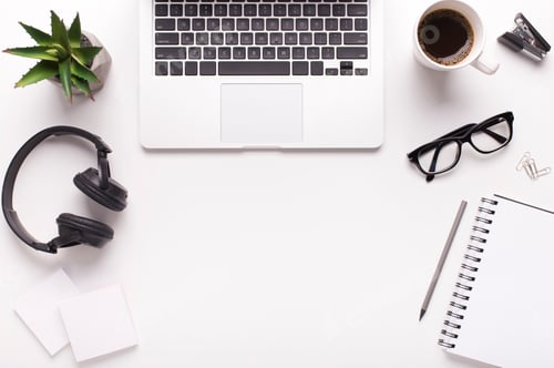 Workspace with Laptop and Office Supplies on White